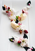 White chocolate mousse with wild strawberries and sugar flowers