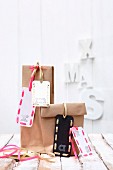 Hand-made festive gift tags with decorative letters on gift bags