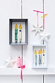 Stylised candles made from rolled banknotes in picture frames as Christmas presents