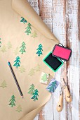 Hand-crafted wrapping paper made from brown paper printed with pattern of Christmas trees