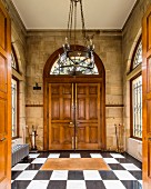 Double doors and exposed stone walls in grand foyer