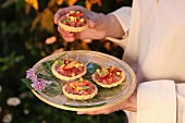 Savoury tartlets with tuna tartare, small slices of lime and peach