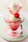 Raspberry ice cream sundaes with a dollop of cream