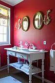 Vintage-style washstand against red wall