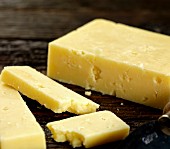 Cheddar cheese on dark wood