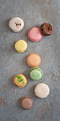 Various macaroons on a stone surface