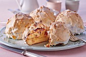 Brioche with meringue and flaked almonds, one sliced