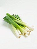 Leeks on a white surface