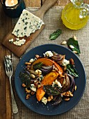 Salad with roasted squash, walnuts, onions and blue cheese