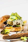 Tuna fish chickpea burger with lemon mayonnaise and cucumber strips