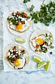 Tacos with sweet potatoes, fried eggs, cheese and coriander