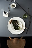 Japanese place setting with sheet of nori, ginger root and chopsticks