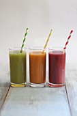 Three fruit and vegetable smoothies in different colours