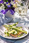 Toast topped with asparagus and Parmesan cheese