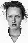 A young brunette woman with lots of freckles (black-and-white shot)