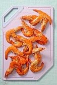 Cooked prawns on a chopping board