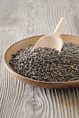 Lentils in a bowl with a wooden scoop