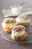 Profiteroles with cream, nuts and icing sugar