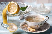 A cup of herbal tea with ginger and lemons