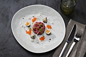 Beef tatar with quail's eggs and caviar