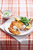 Chicken escalope with a fatty cheese crust and tzatziki