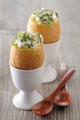 Potatoes topped with chive quark in egg cups