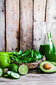 Ingredients for green smoothies on a rustic wooden surface