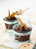 Chocolate cake with sesame brittle in glasses as a gift