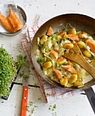 Fried pointed cabbage and gnocchi with salmon and cress