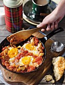 A breakfast pan of potatoes, tomatoes and egg