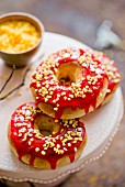 Doughnuts with red icing and nut brittle
