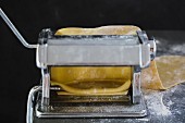 Fresh pasta dough in a pasta machine
