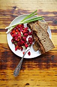 Russian beetroot salad with country bread and spring onions