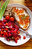 Beetroot salad with bread and butter with salmon caviar (Russia)