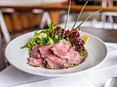 Roast beef with a mixed leaf salad in a restaurant