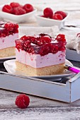 A slice of raspberry cheesecake with raspberry jelly