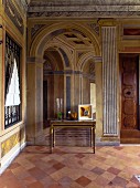 Foyer of palazzo with trompe l'oeil fresco and terracotta floor