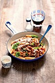 Penne pasta with beef ragout, Parmesan cheese and basil