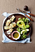 Fish fillet with a Parmesan crust and an avocado and watercress salad