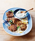 Mackerel and courgette cakes with tzatziki and lemon wedges