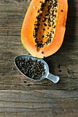 A fresh papaya and papaya seeds