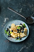 Grilled Halloumi with blueberries and mint on polenta