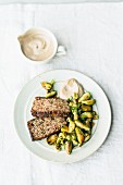 Roasted vegetarian nut and mountain cheese loaf with stir-fried Brussels sprouts and a tahini dip