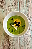 Cold pea soup with edamame beans, basil, mint and pansies