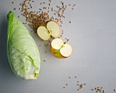 Grains, pointed cabbage and a halved apple