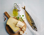 A bottle of oil, mackerel and cheese