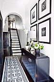 Black and white staircase in an elegantly renovated old building with a round arch