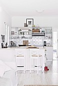 Open kitchen with white kitchenette, wall tiles and kitchen counter