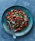Winter bulgur salad with pomegranate seeds, radishes and tomatoes