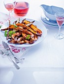 Spiced, roasted butternut squash slices with sweet potato wedges